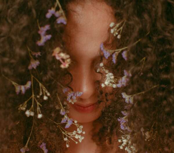 Unrecognizable woman with curly hair