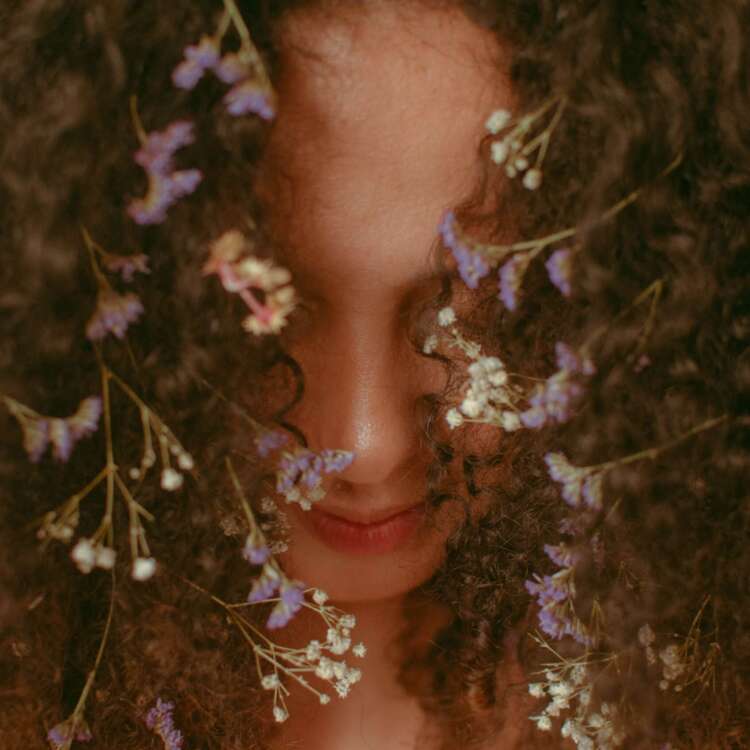 Unrecognizable woman with curly hair